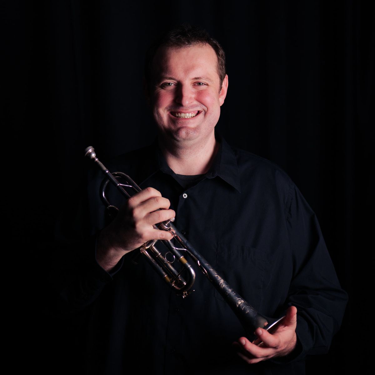 Mathew Harwich holding his trumpet